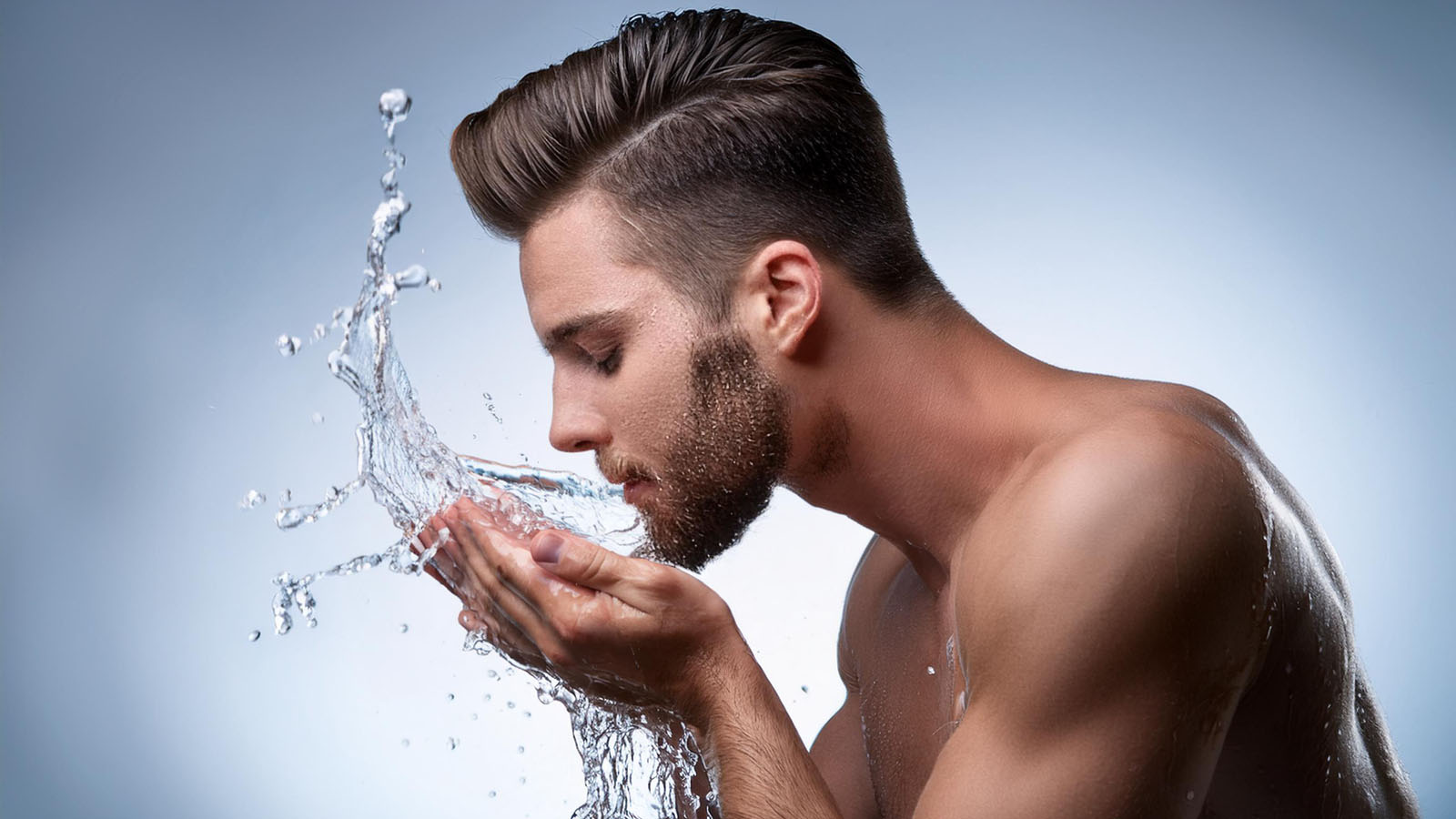 man using face wash to clean his face.