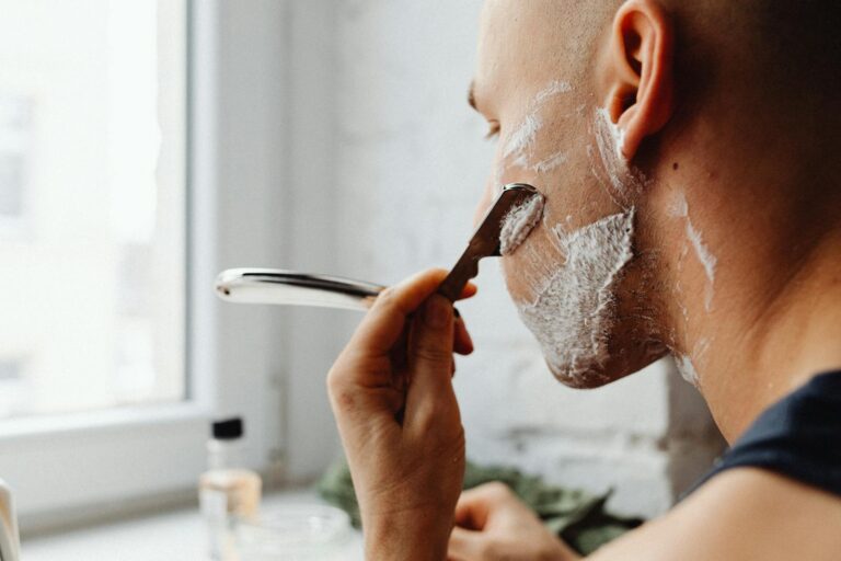 man shaving as one of his grooming habits